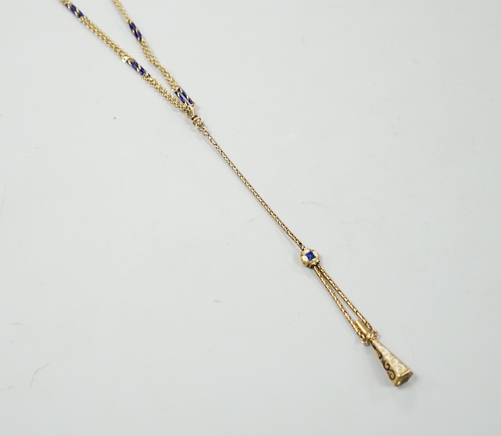 An early 20th century yellow metal overlaid, two colour enamel and citrine set watch key, on a 585 yellow metal and two colour enamel twin strand albertina, overall 88cm, gross weight 21.5 grams.